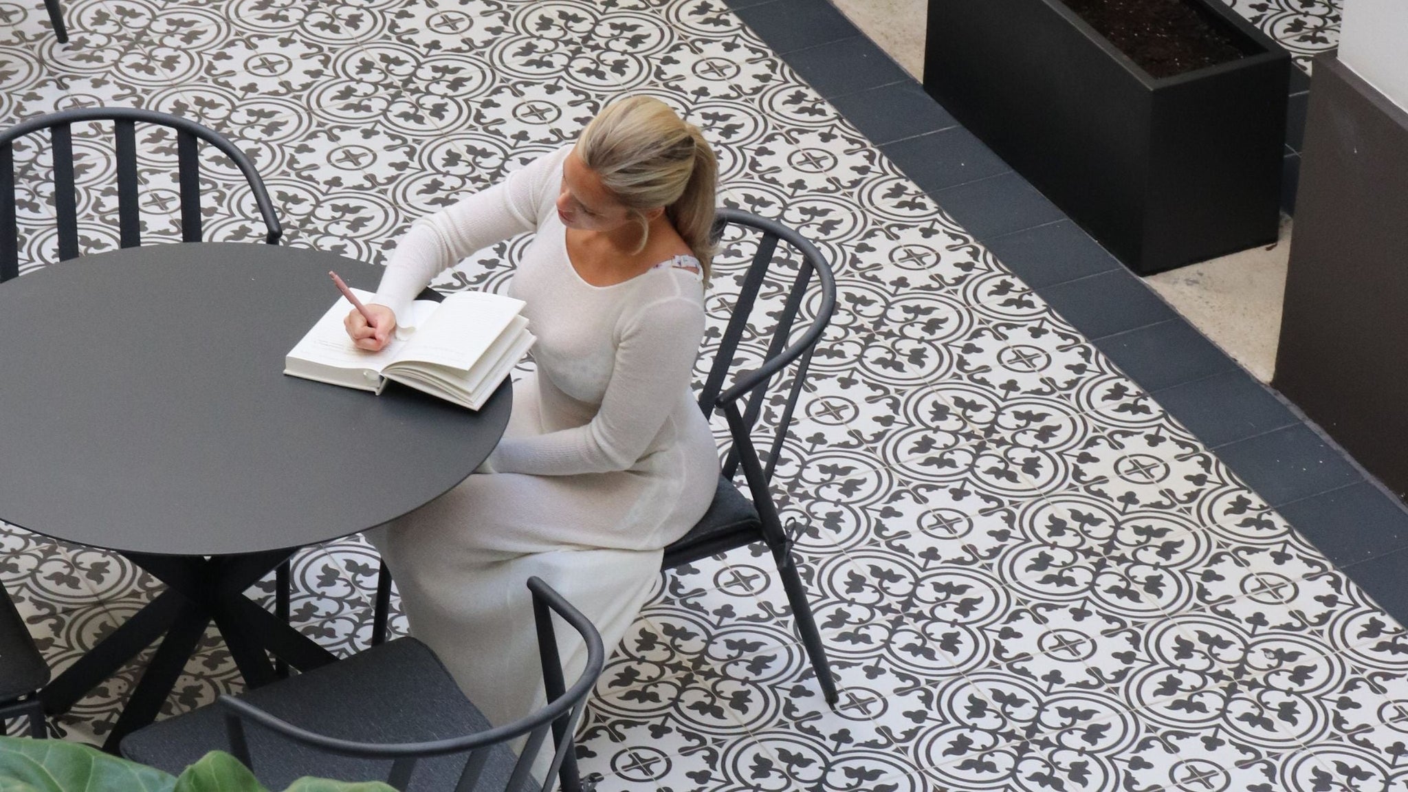 Woman sitting at a table with the 365 Journal