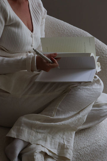Close up of a woman flipping through the 365 Journal