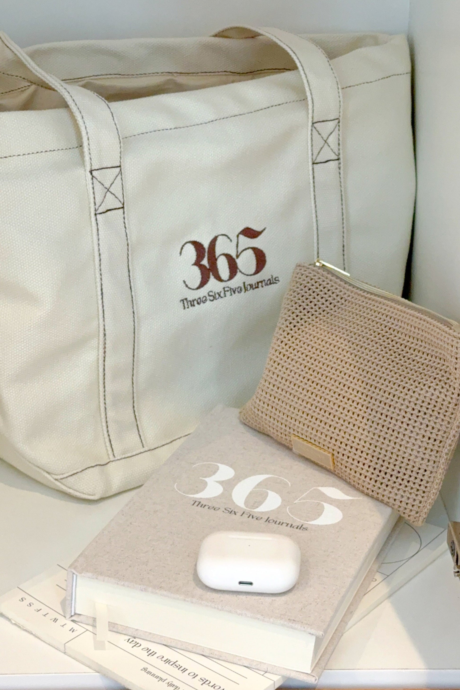 365-themed tote bag, book, and pouch on a white surface
