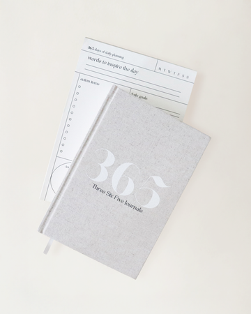 365 Journal sitting on top of the Daily Align notepad on a cream background